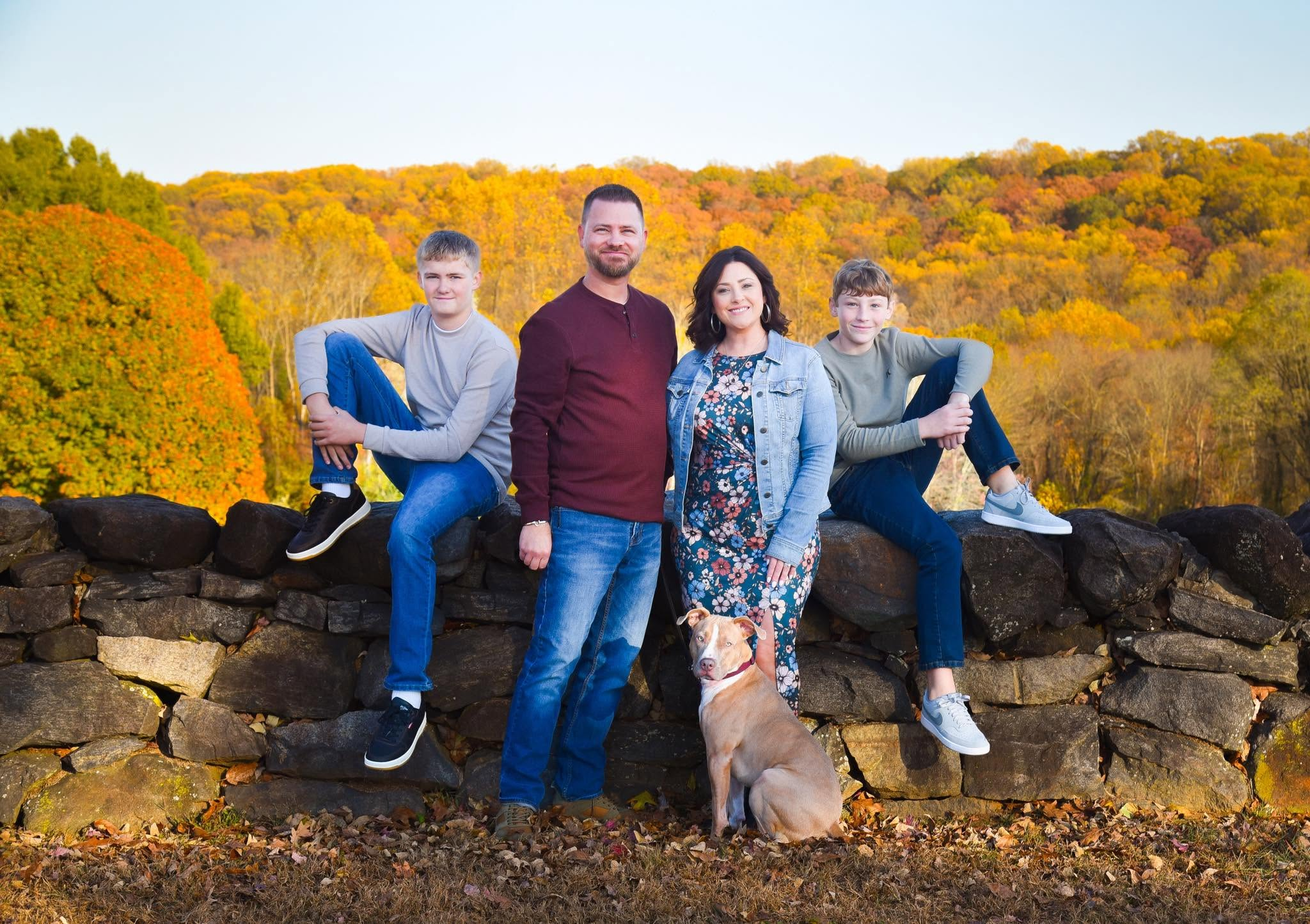Family portrait with a dog in an autumn landscape